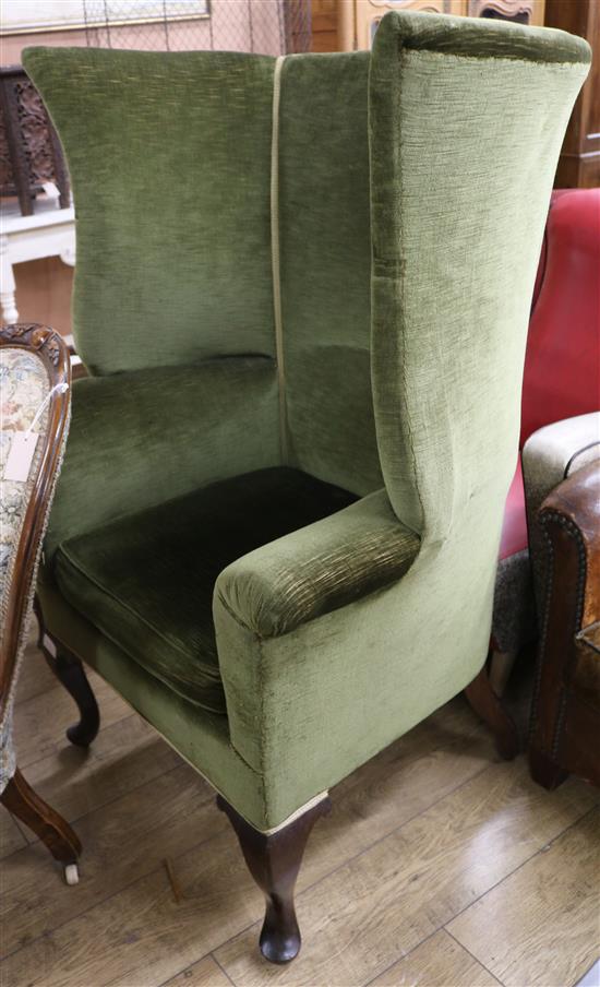 An upholstered wing back armchair